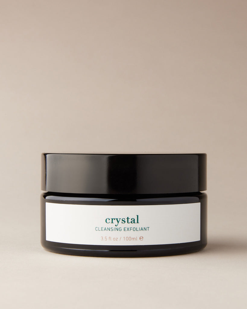 Jar of ISUN Crystal Cleansing Exfoliant on a beige background