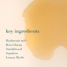 Product with a close-up of a golden liquid and text listing key ingredients on a beige background.
