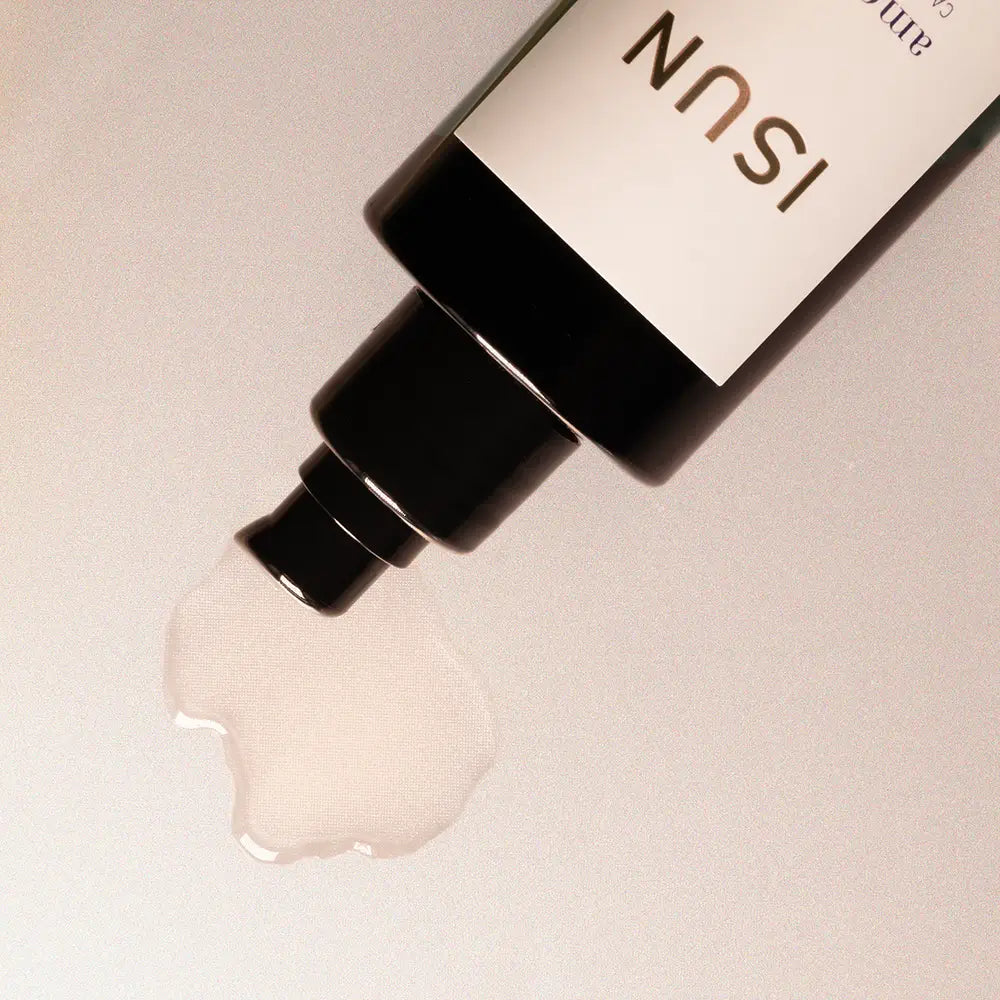 ISUN skincare product with a droplet of oil on a light background