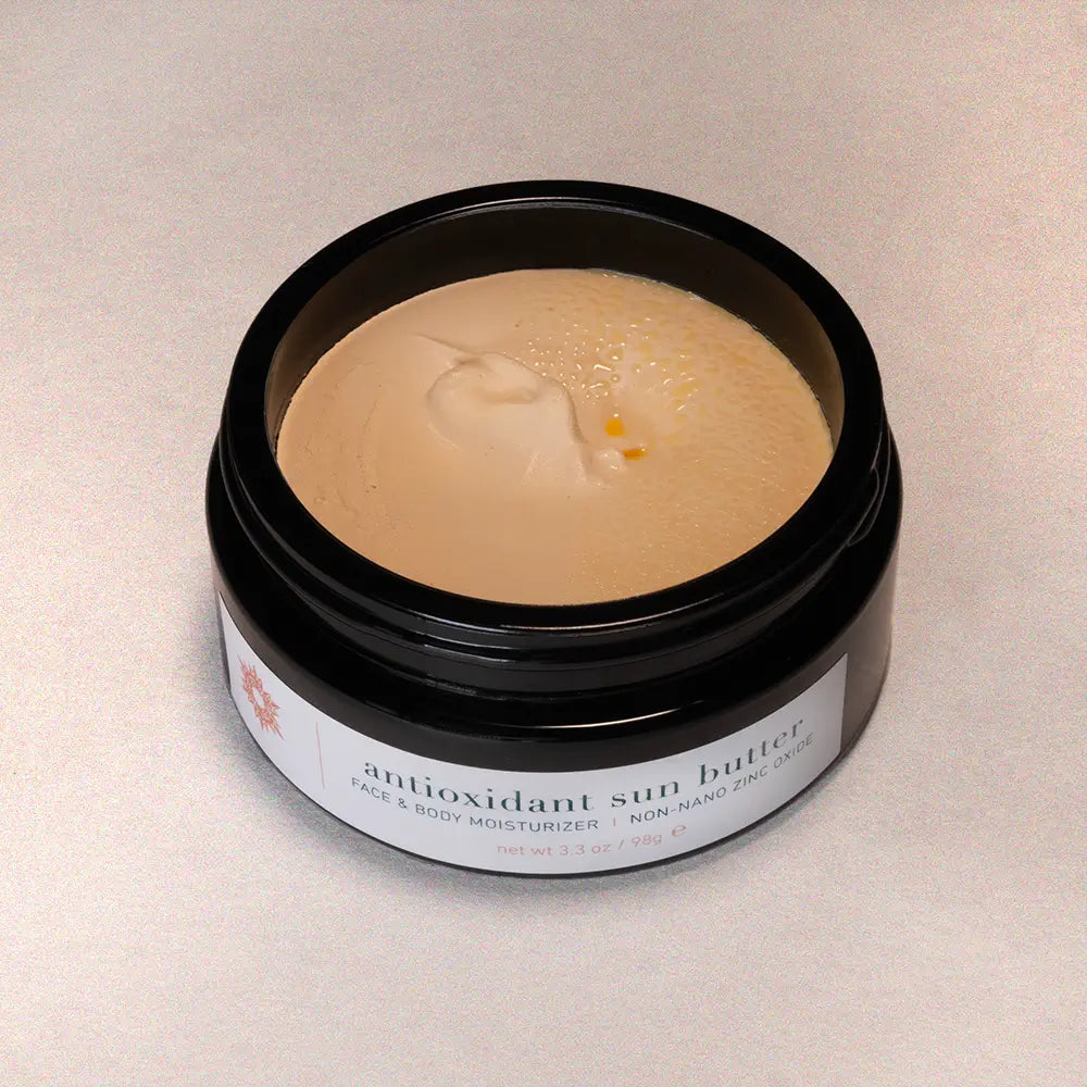 Jar of antioxidant sun butter on a beige background