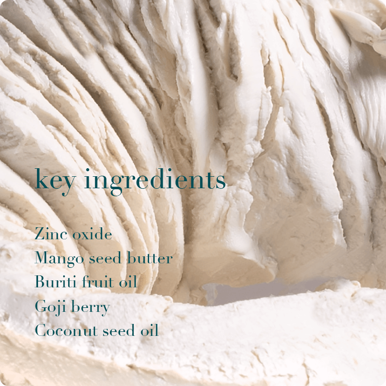 Close-up of a creamy texture with text listing key ingredients.