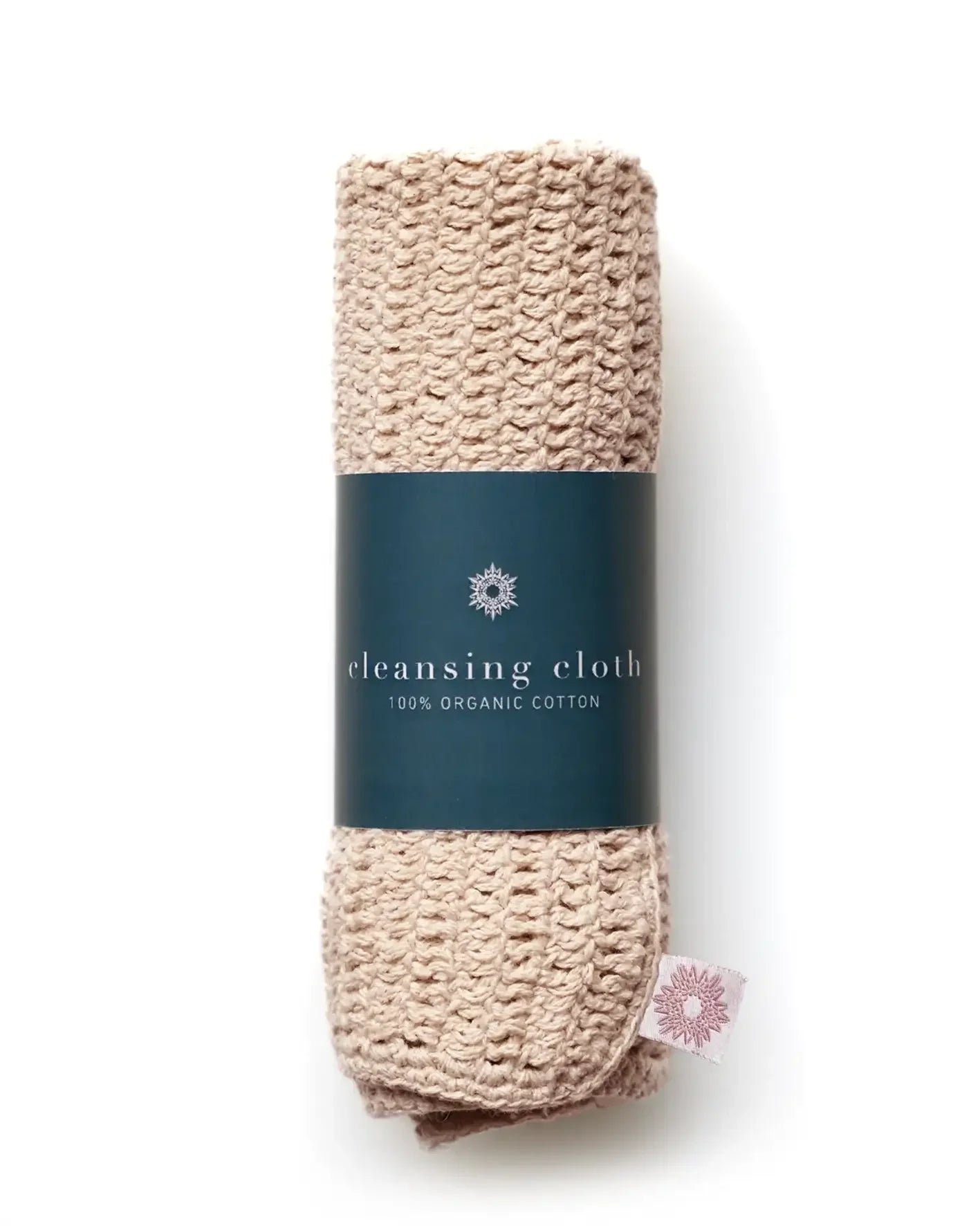 Beige crochet cleansing cloth with a teal green label on a white background