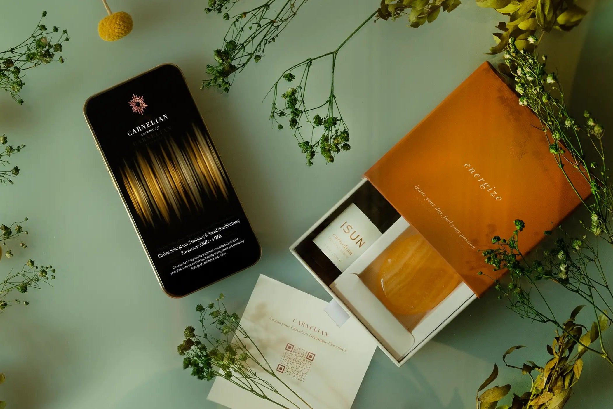 Phone with a floral arrangement on a light green surface