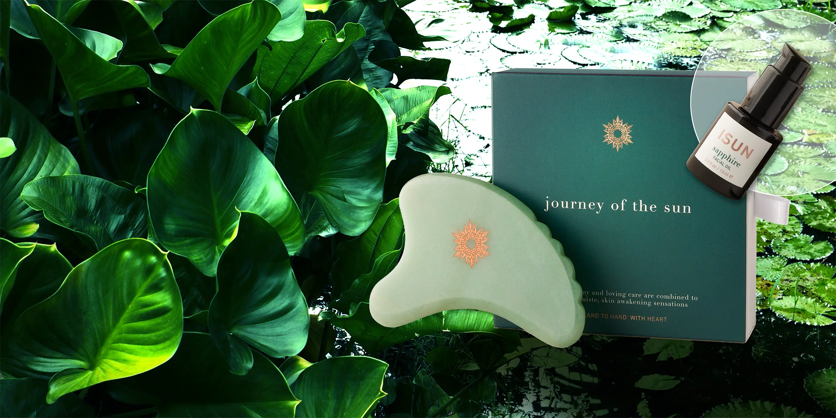 Green gua sha tool with a box labeled 'journey of the sun' on a leafy background
