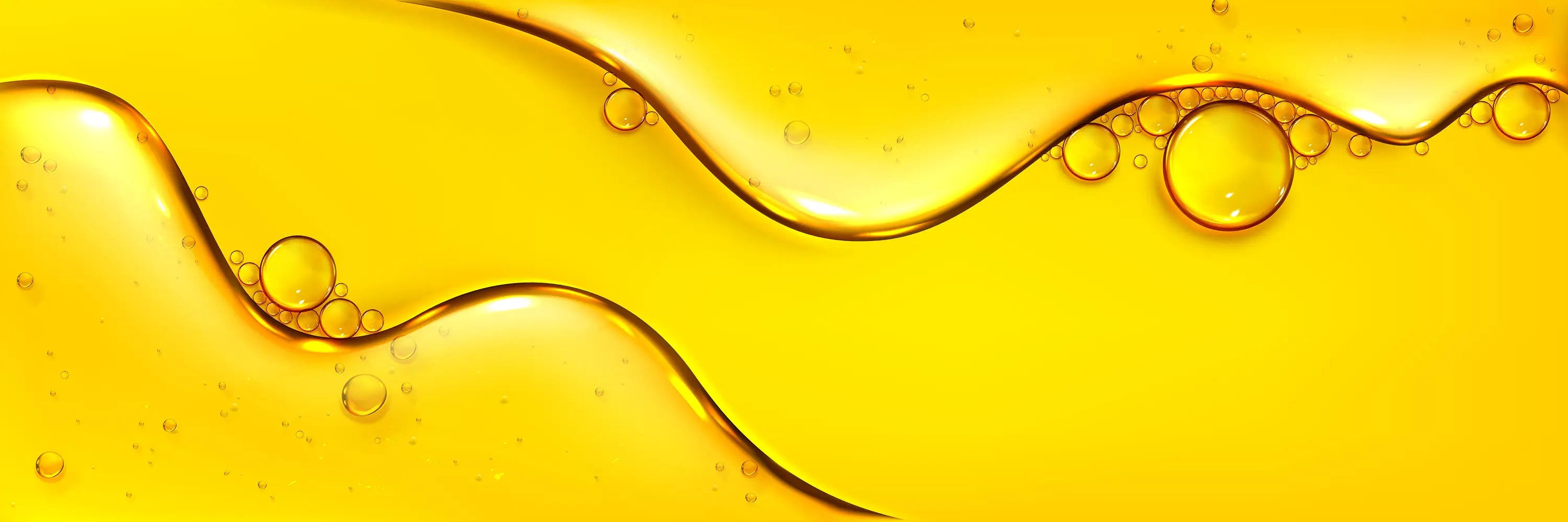 Close-up of yellow liquid with bubbles on a yellow background
