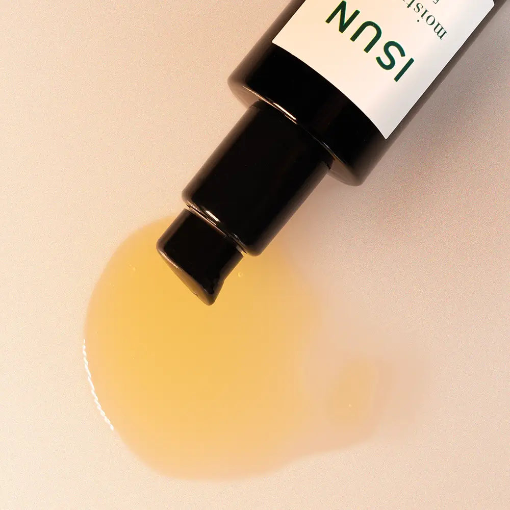ISUN skincare product being dispensed onto a beige background