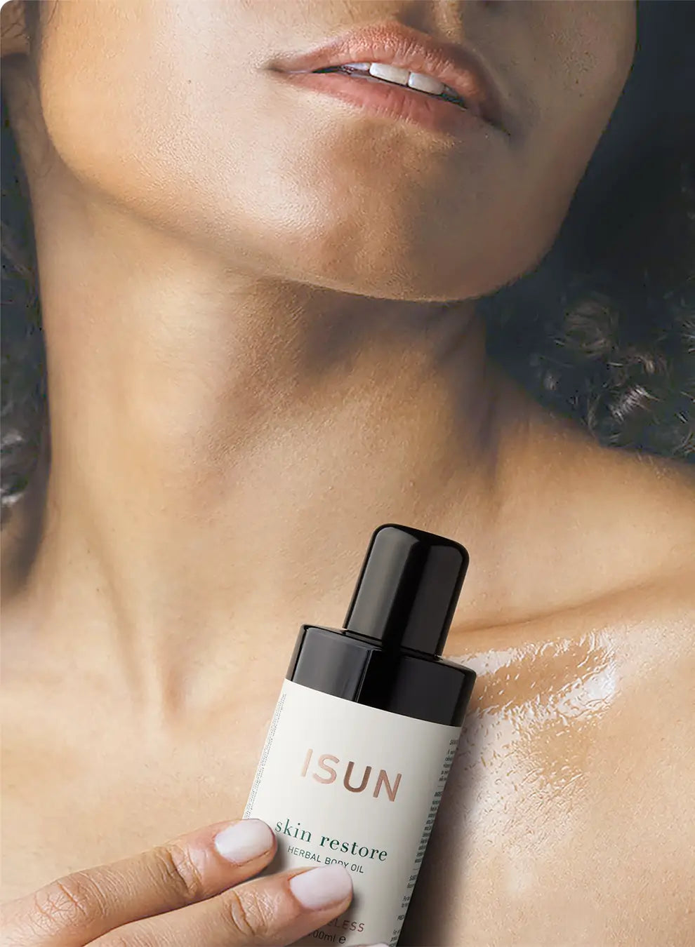 Hand holding a skincare product labeled 'ISUN' against a blurred background of a person's neck.