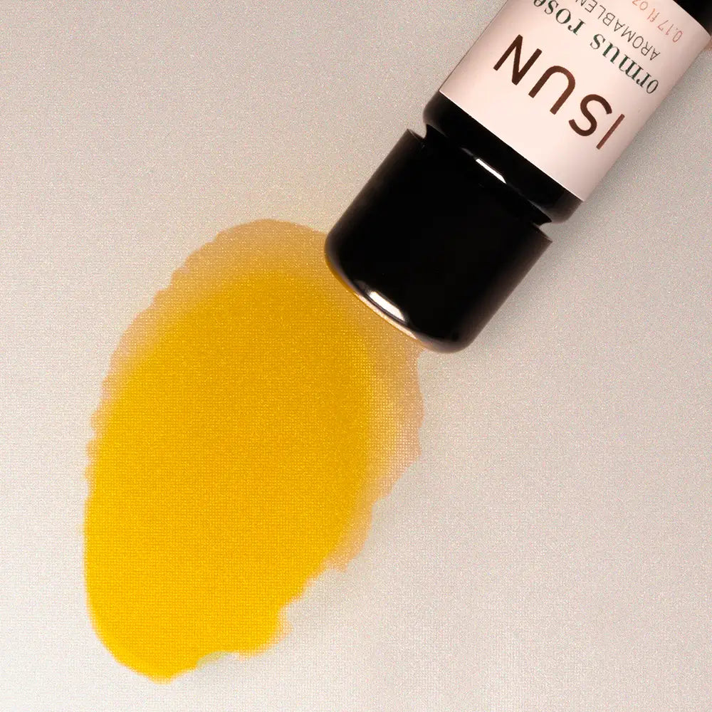 ISUN essential oil bottle with a yellow droplet on a light background