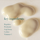 Key ingredients of a skincare product with liquid droplets on a light background