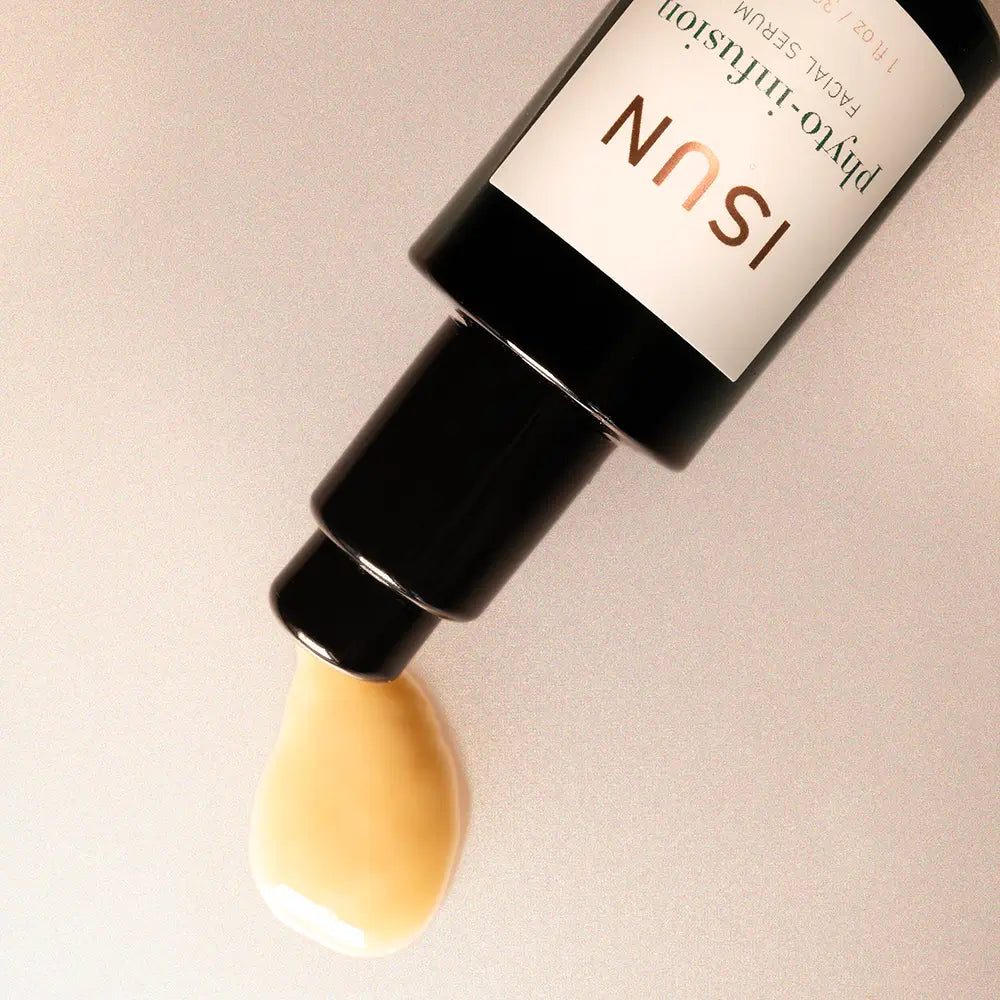 ISUN skincare serum bottle with a droplet of serum on a beige background