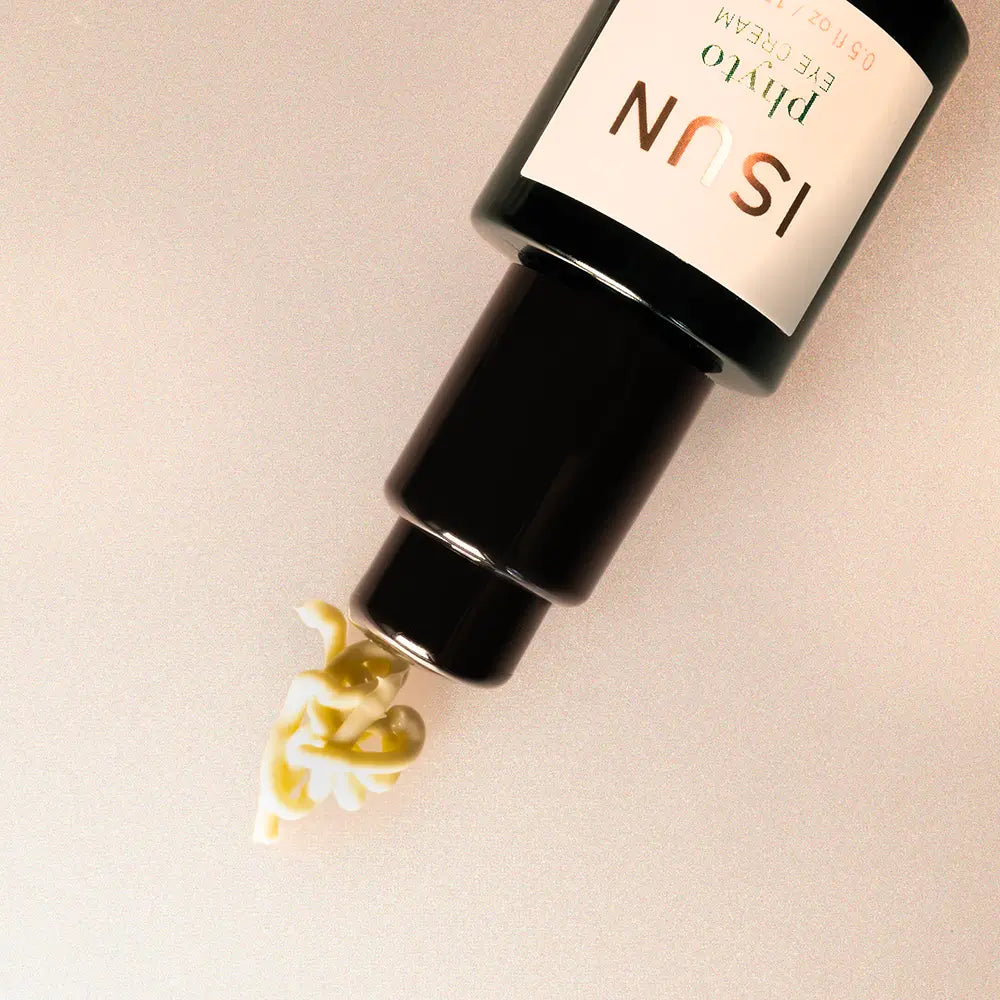 Black bottle with a dropper labeled 'ISUN' on a beige background