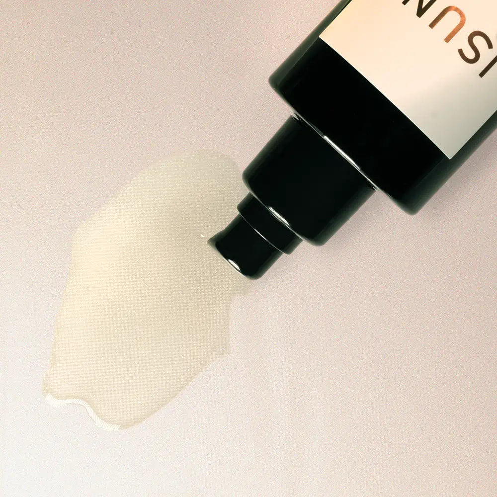 Cosmetic product being applied with a brush on a light background