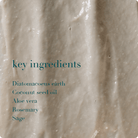 Close-up of a beige cream with text listing key ingredients