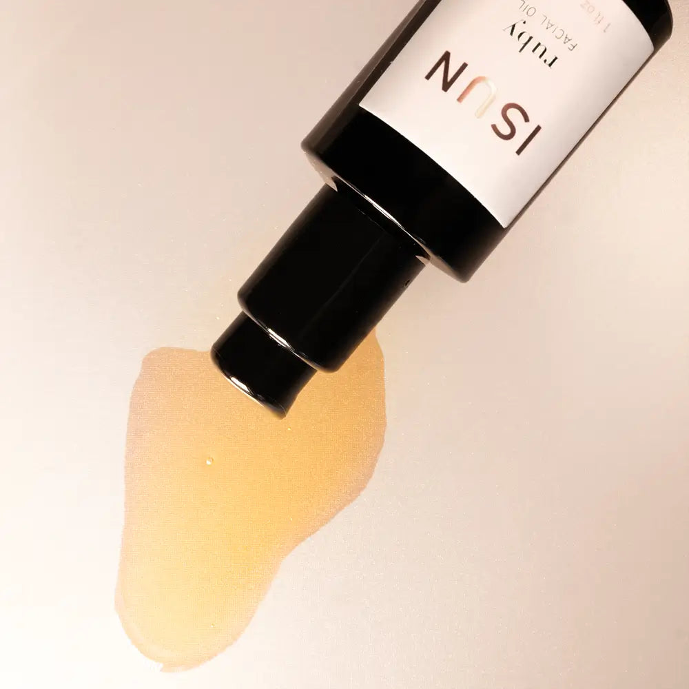 ISUN skincare product with a droplet of oil on a beige background
