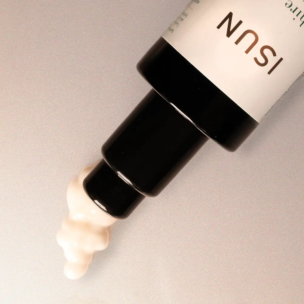 Cosmetic bottle with visible brand name on a neutral background