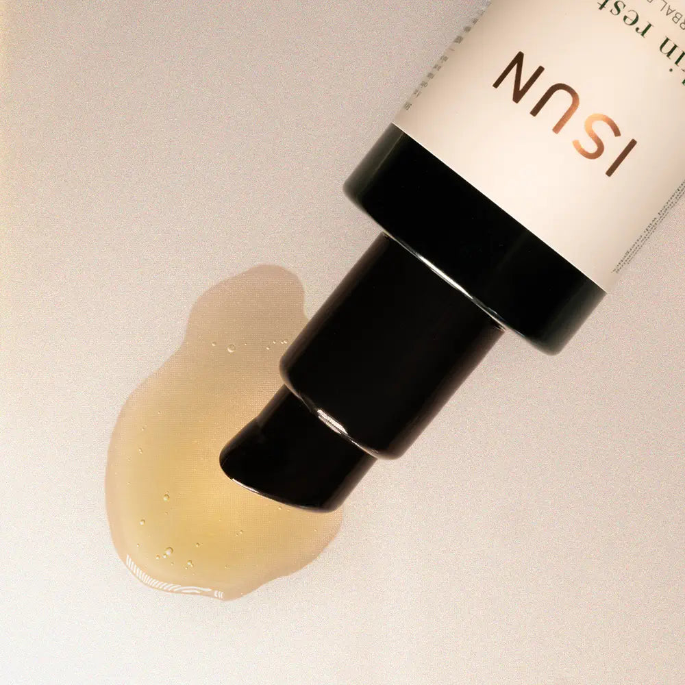 ISUN skincare product with a droplet of oil on a neutral background