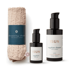 ISUN Solstice Ritual with Sapphire Cleanse, Sapphire Facial Oil and a rolled cotton face cloth on a white background.