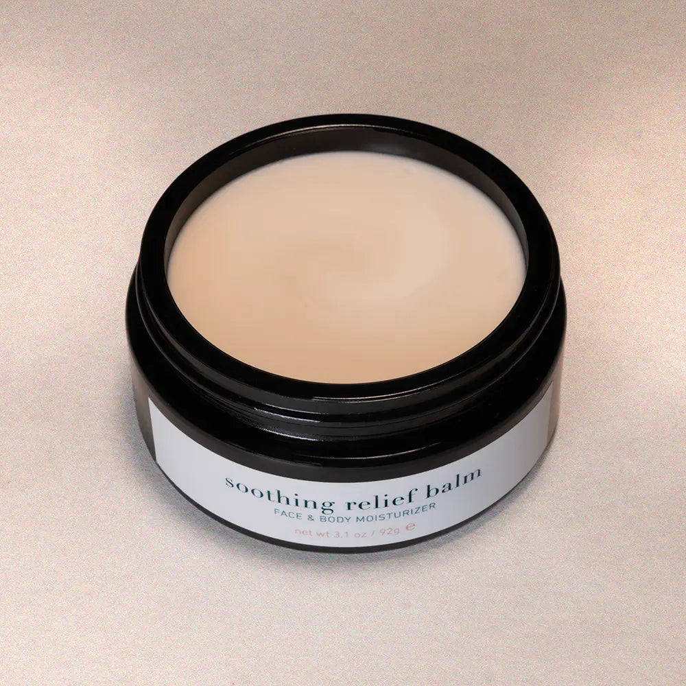 Jar of soothing relief balm on a beige background