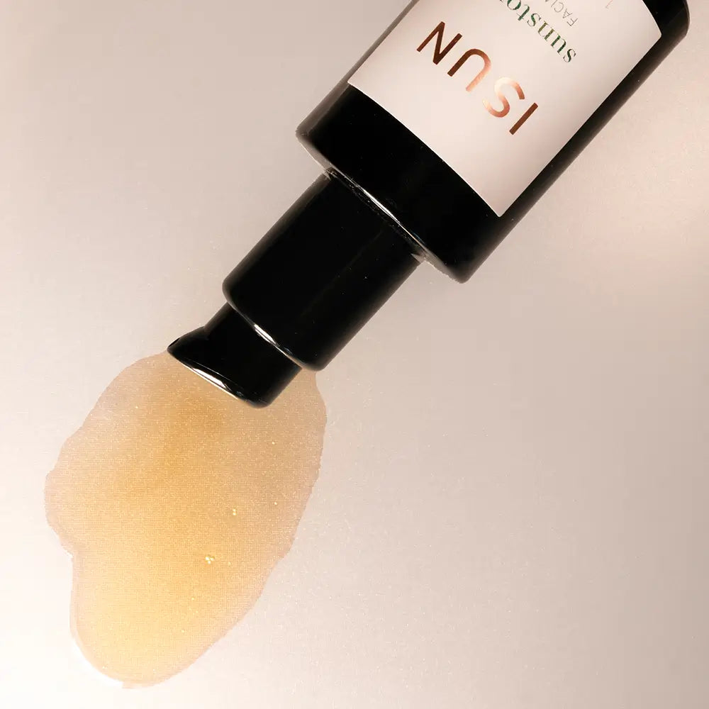 Bottle with beige oil on a light background