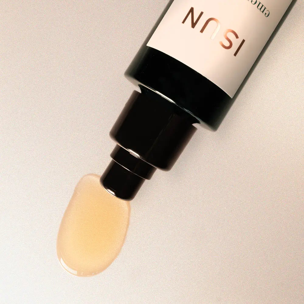 Cosmetic dropper with beige liquid on a light gray background, featuring the brand ISUN.
