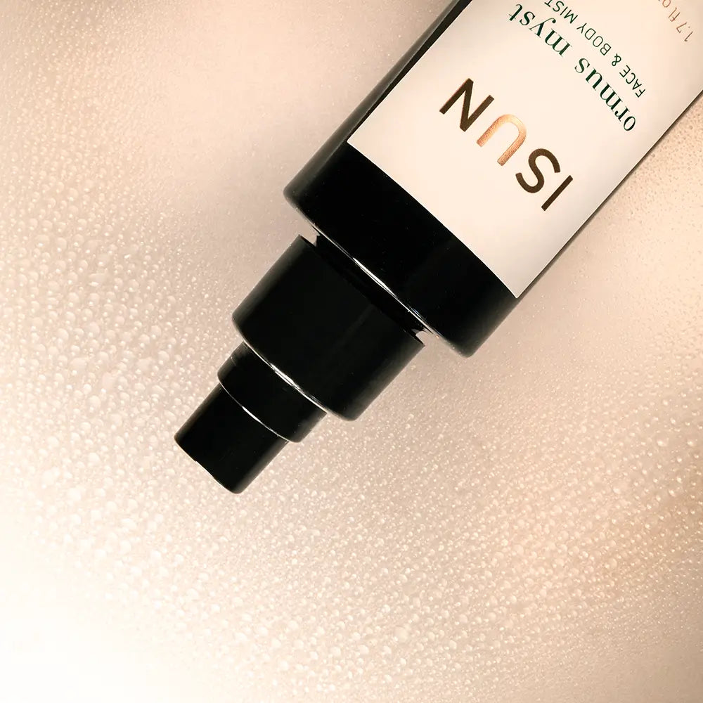 ISUN skincare bottle on a textured beige background