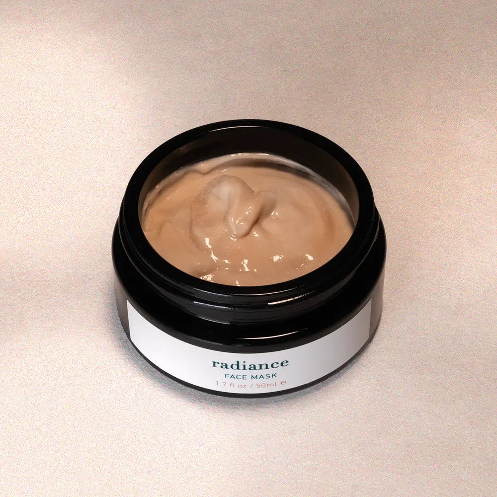 Jar of 'radiance' face mask on a beige background